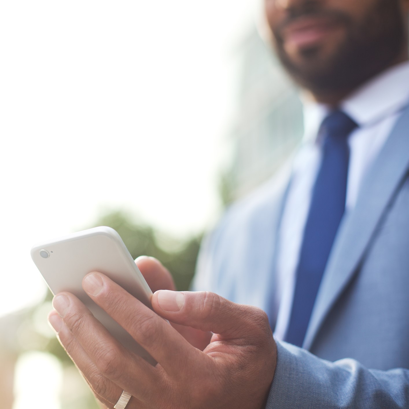 Businessman Using Smartphone [881515072] - Copy